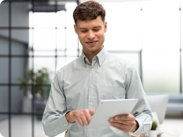 modern-business-man-using-digital-tablet-while-standing-office 1