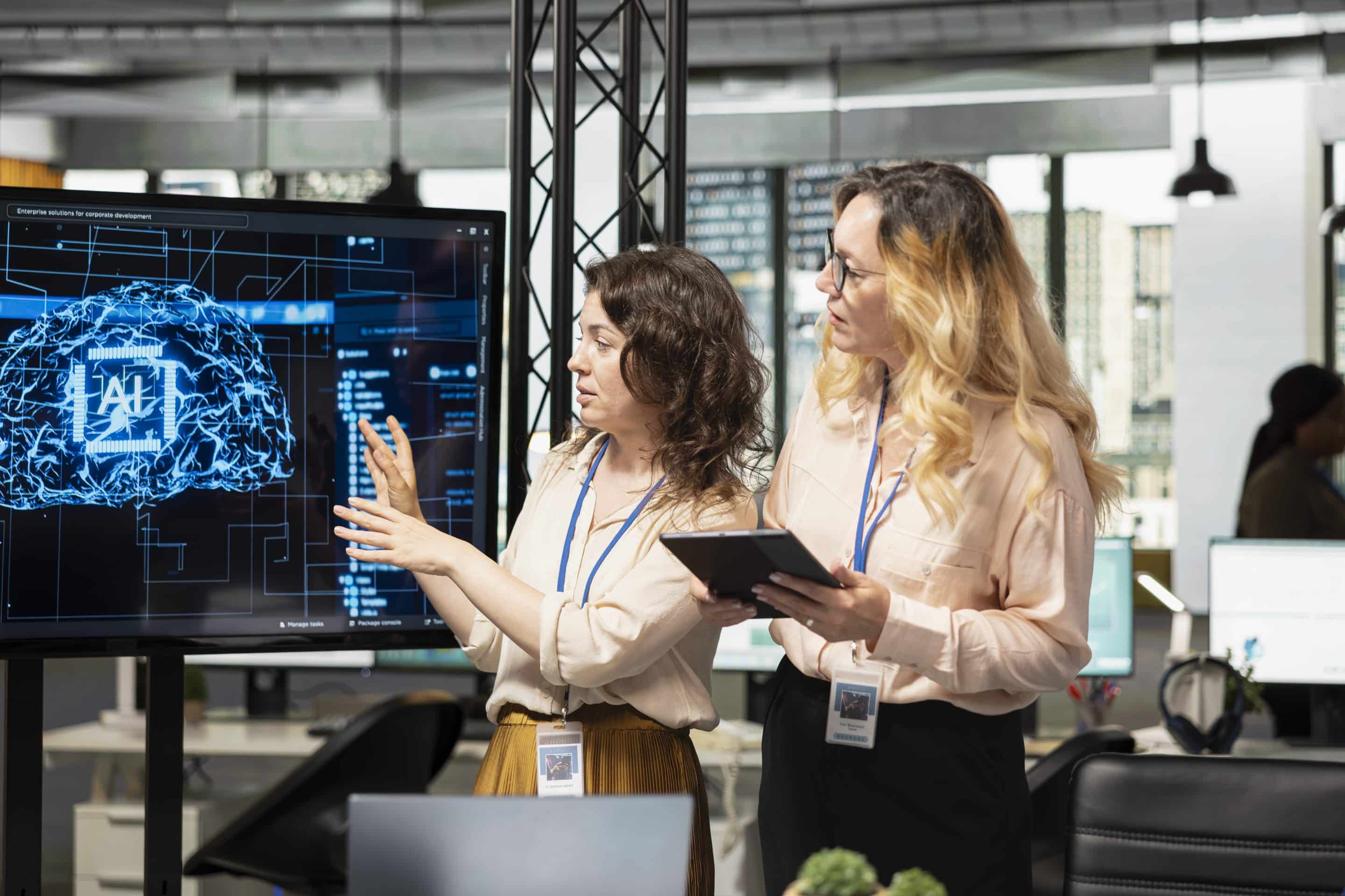 Team of coworkers using strategic artificial intelligence cloud computing Equipo profesional revisando el uso de IA en la empresa y su impacto laboral y preventivo, tal y como obliga la ley